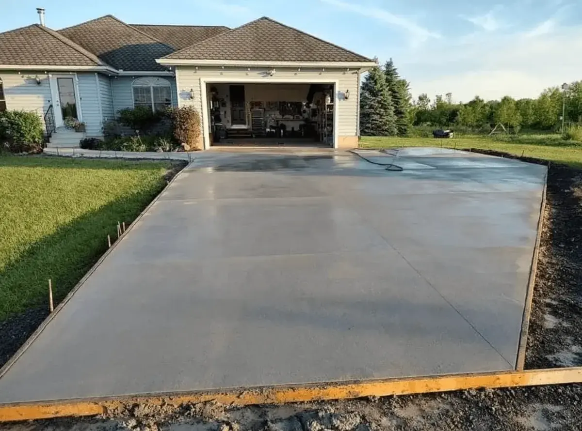 New concrete driveway poured to an attached garage in Orchard Park NY — Cornerstone Concrete of WNY